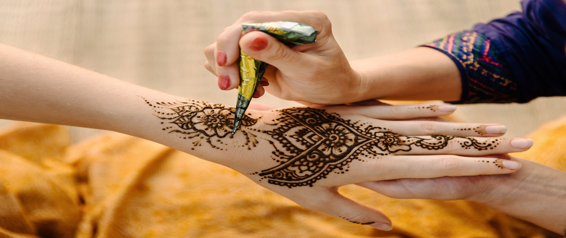 Making Mehendi design on hand